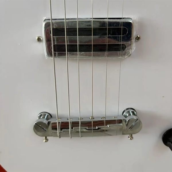 Red electric guitar with white pickguard